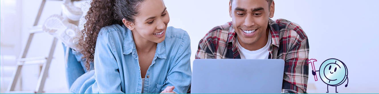 A couple looking at home plans on a laptop computer.